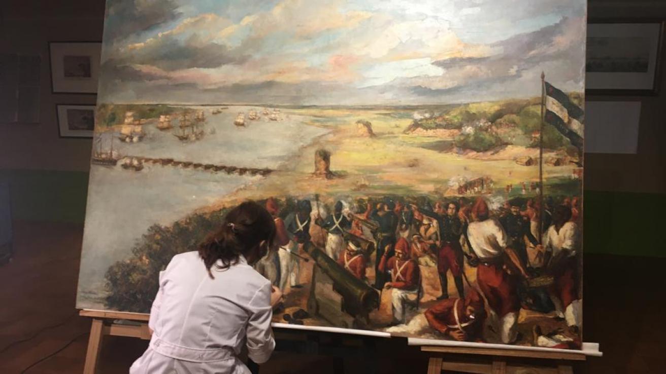 mujer restaurando cuadro